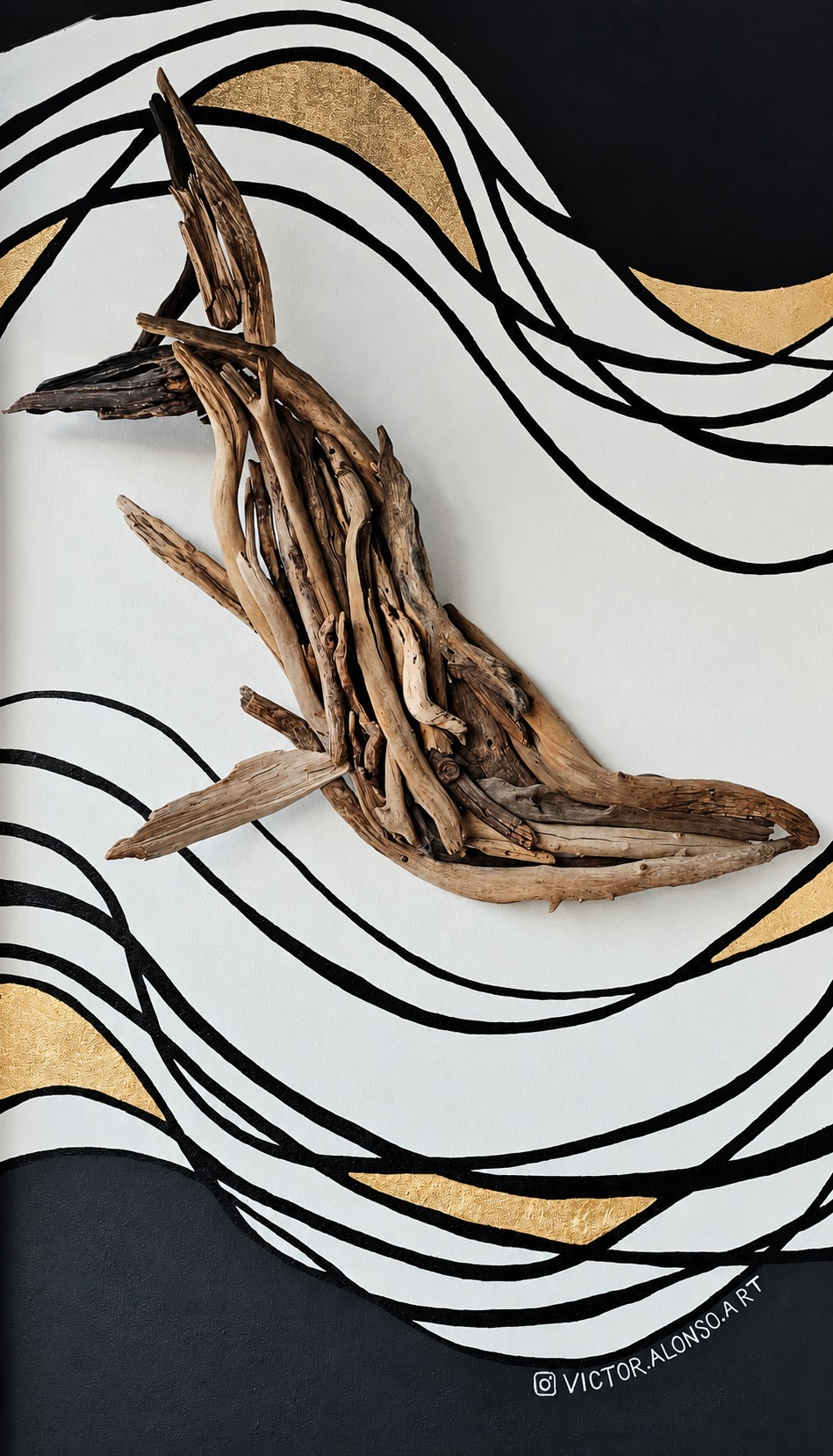 Driftwood whale wall piece on painted wave mural