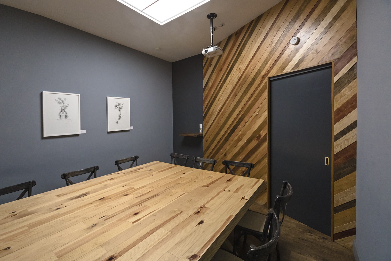 Meeting room with wood table and slatted wall